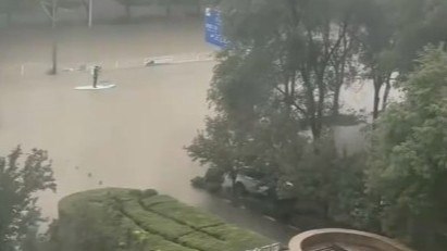 沈阳暴雨 路人撑船穿梭街道